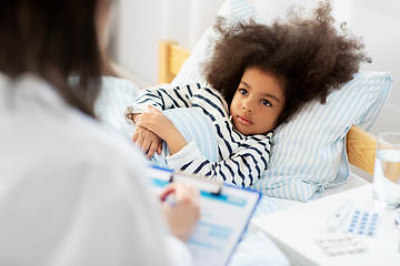 Image showing doctor with clipboard and sick girl in bed at home