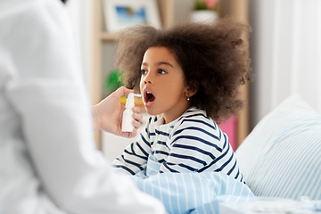 Image showing doctor with medicine treats sick girl at home