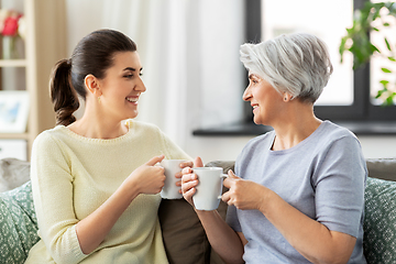 Image showing senior mother and adult daughter drinking coffee