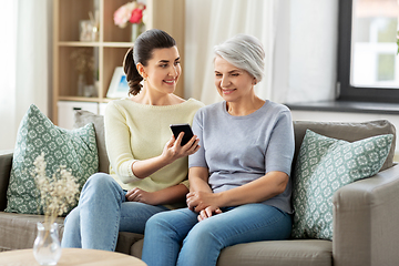 Image showing daughter and senior mother with smartphone at home