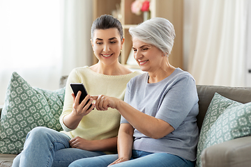 Image showing daughter and senior mother with smartphone at home