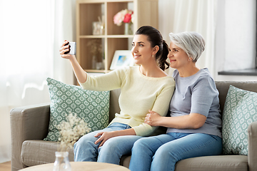 Image showing senior mother with daughter taking selfie at home