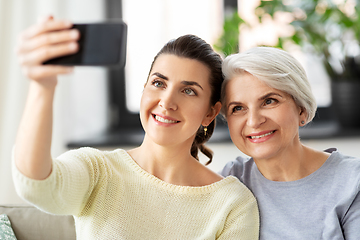 Image showing senior mother with daughter taking selfie at home