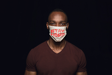 Image showing Man in protective mask with words STAY HOME, coronavirus prevention, protection concept