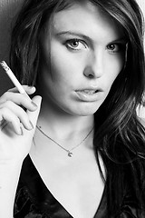 Image showing young beautiful girl smoking