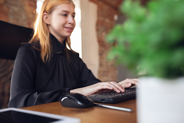 Image showing Caucasian young woman in business attire working in office