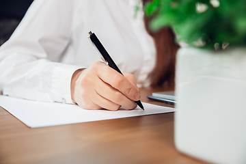 Image showing Caucasian young woman in business attire working in office