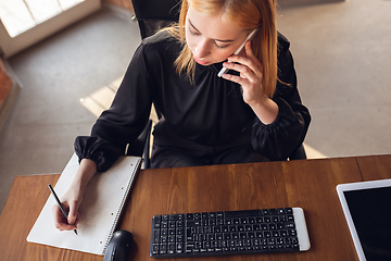 Image showing Caucasian young woman in business attire working in office