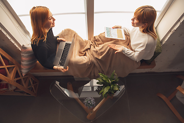 Image showing Young friends, women using gadgets to watch cinema, photos, online courses, taking selfie or vlog