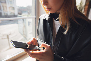 Image showing Young woman using gadgets to watch cinema, photos, online courses, taking selfie or vlog, online shopping