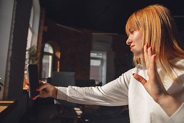 Image showing Young woman using gadgets to watch cinema, photos, online courses, taking selfie or vlog, online shopping