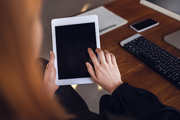 Image showing Caucasian young woman in business attire working in office