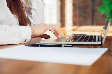 Image showing Caucasian young woman in business attire working in office