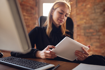 Image showing Caucasian young woman in business attire working in office