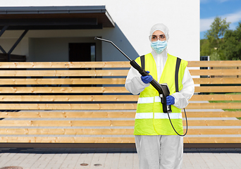 Image showing sanitation worker in hazmat with pressure washer