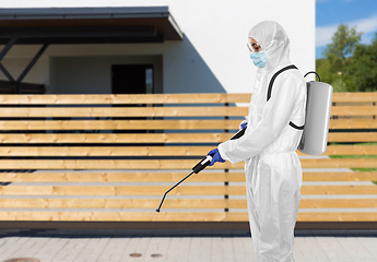 Image showing sanitation worker in hazmat with pressure washer