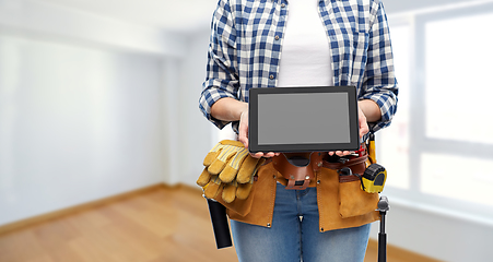 Image showing woman builder with working tools showing tablet pc