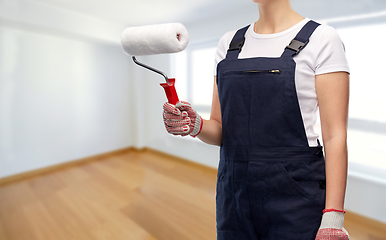 Image showing close up of painter or builder with paint roller