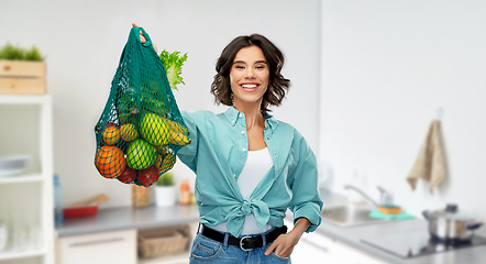 Image showing happy smiling woman with food in reusable net bag