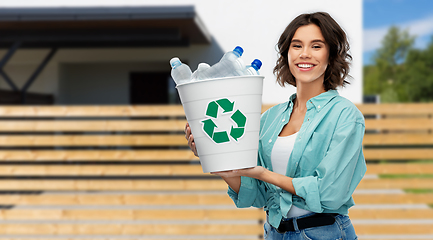 Image showing smiling young woman sorting plastic waste