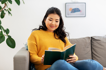 Image showing asian young woman reading book at home