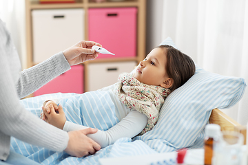 Image showing mother measuring temperature of sick daughter