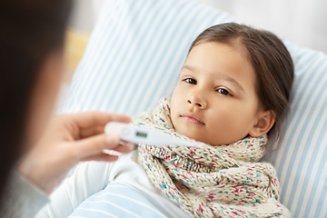 Image showing mother measuring temperature of sick daughter