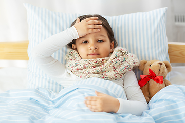 Image showing sick little girl lying in bed at home