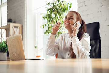 Image showing Caucasian young woman in business attire working in office