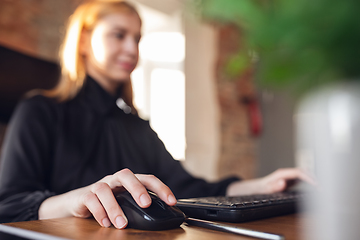 Image showing Caucasian young woman in business attire working in office