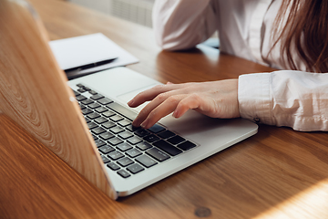 Image showing Caucasian young woman in business attire working in office