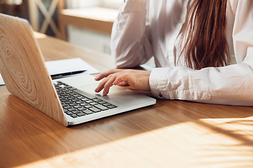 Image showing Caucasian young woman in business attire working in office