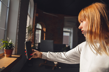 Image showing Young woman using gadgets to watch cinema, photos, online courses, taking selfie or vlog, online shopping