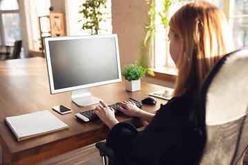 Image showing Caucasian young woman in business attire working in office