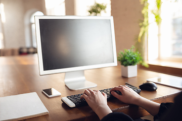 Image showing Caucasian young woman in business attire working in office