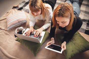 Image showing Young friends, women using gadgets to watch cinema, photos, online courses, taking selfie or vlog, top view