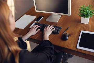 Image showing Caucasian young woman in business attire working in office