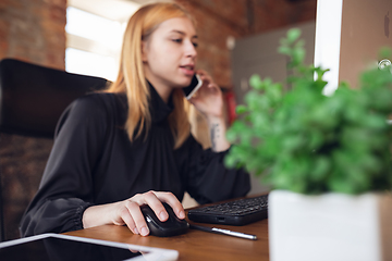 Image showing Caucasian young woman in business attire working in office