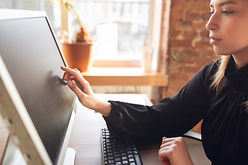 Image showing Caucasian young woman in business attire working in office