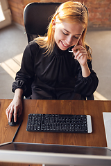 Image showing Caucasian young woman in business attire working in office