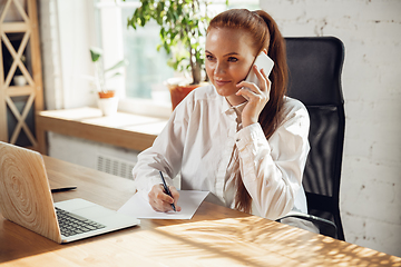 Image showing Caucasian young woman in business attire working in office