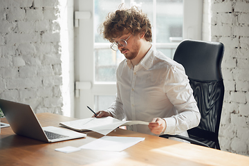 Image showing Caucasian young man in business attire working in office, job, online studying