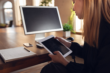 Image showing Caucasian young woman in business attire working in office