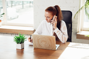 Image showing Caucasian young woman in business attire working in office