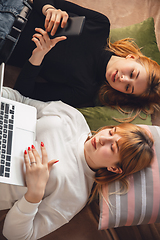 Image showing Young friends, women using gadgets to watch cinema, photos, online courses, taking selfie or vlog, top view