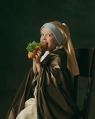 Image showing Medieval little girl as a lady with a pearl earring on dark studio background. Concept of comparison of eras, childhood. Stylish creative design, art vision, new look of artwork.