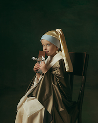 Image showing Medieval little girl as a lady with a pearl earring on dark studio background. Concept of comparison of eras, childhood. Stylish creative design, art vision, new look of artwork.