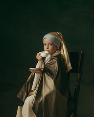 Image showing Medieval little girl as a lady with a pearl earring on dark studio background. Concept of comparison of eras, childhood. Stylish creative design, art vision, new look of artwork.