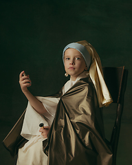 Image showing Medieval little girl as a lady with a pearl earring on dark studio background. Concept of comparison of eras, childhood. Stylish creative design, art vision, new look of artwork.