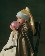 Image showing Medieval little girl as a lady with a pearl earring on dark studio background. Concept of comparison of eras, childhood. Stylish creative design, art vision, new look of artwork.